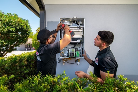 2 Technicians Repairing Tankless Water Heater