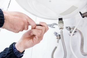 repairing pipe under sink