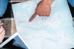 person pointing at map