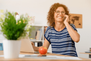 person smiling while on the phone